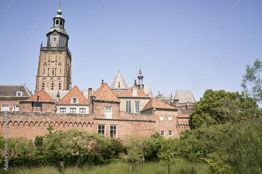 Zutphen's ancient city walls with homes, gardens and the Walburgis Church