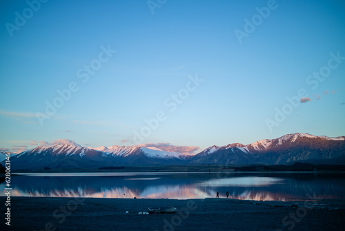 A cold sunset against a blue lake in Tekapo, New Zealand.