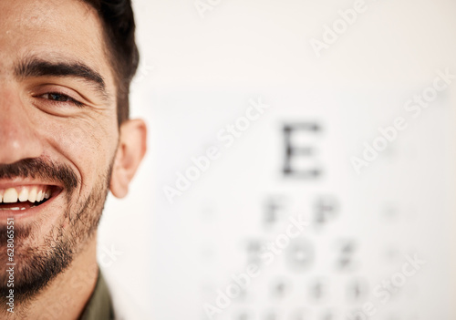Face banner, optometrist and man with eye chart in hospital for vision, wellness or healthcare. Portrait, ophthalmologist and happy person with snellen graph, doctor smile or optician on mockup space photo