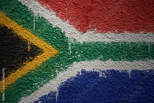 painted big national flag of south africa on a massive old cracked wall