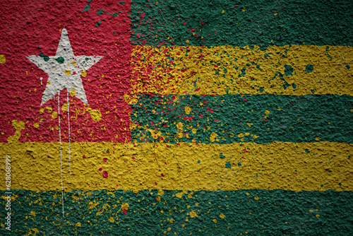 painted big national flag of togo on a massive old cracked wall