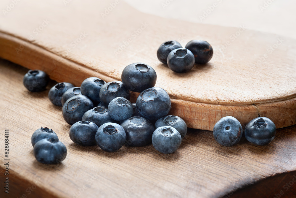 Blueberry. Blueberries on a wooden surface close-up. Sprinkle blueberries. Scattered fresh blueberries. Fresh organic food. Selective focus Blueberry. Blueberries on a wooden surface close-up. Sprinkle blueberries. Scattered fresh blueberries. Fresh organic food. Selective focus