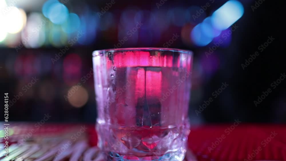 4K Professional male bartender pouring mixed blue liquor cocktail drink from cocktail shaker into shot glass on bar counter at nightclub. Mixologist barman making alcoholic drink serving to customer 4K Professional male bartender pouring mixed blue liquor cocktail drink from cocktail shaker into shot glass on bar counter at nightclub. Mixologist barman making alcoholic drink serving to customer