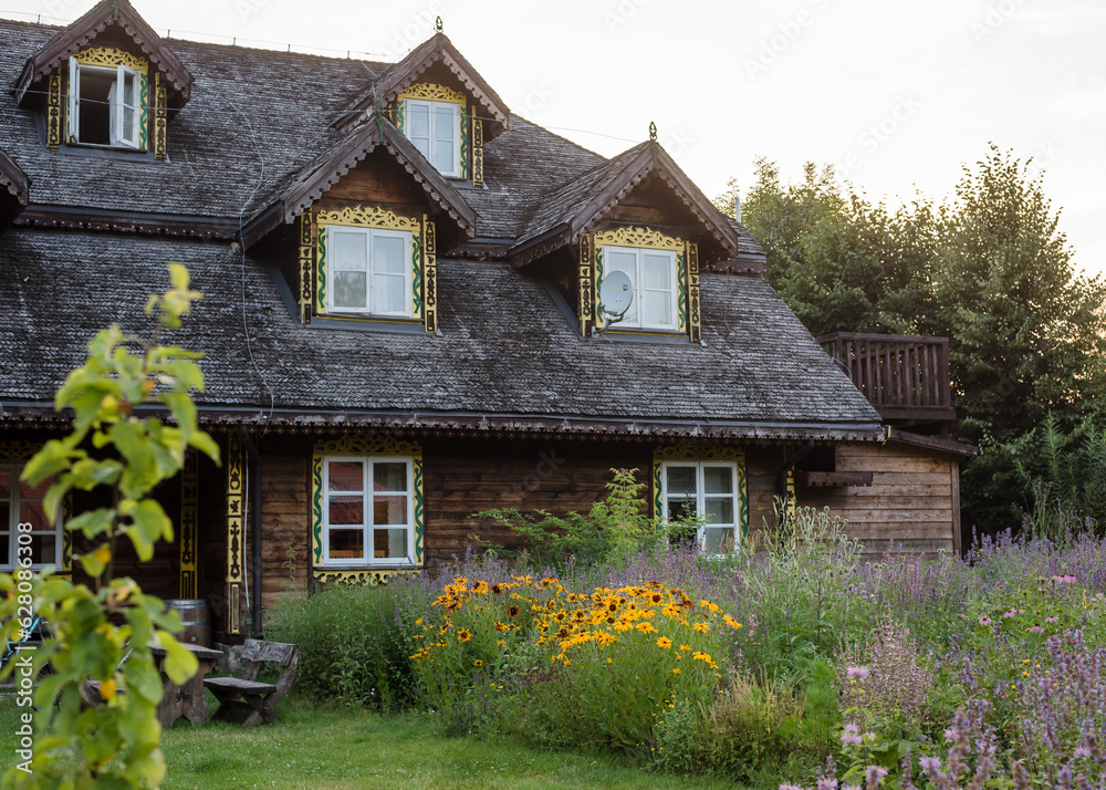 Old large wooden house with beautiful grounds in a polish village. House in Podlaskie Voivodeship Style which is on Northern Poland. Old large wooden house with beautiful grounds in a polish village. House in Podlaskie Voivodeship Style which is on Northern Poland.