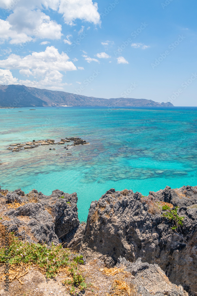 View of the rocks and crystal clear water of The Mediterranean Sea on the background, Elafonissi, Kissamos, Crete, Greece