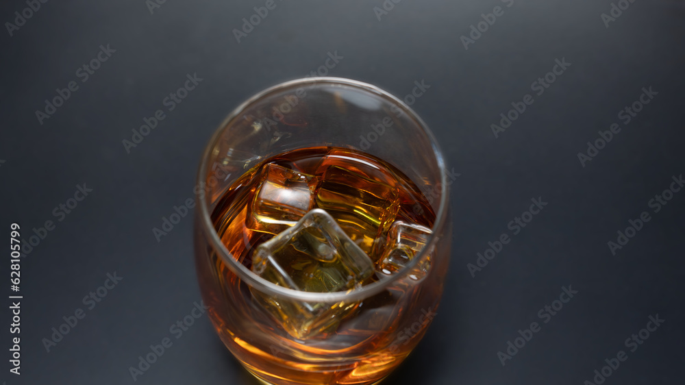 Ice cube whiskey glass isolated on black background whiskey on the rocks	
