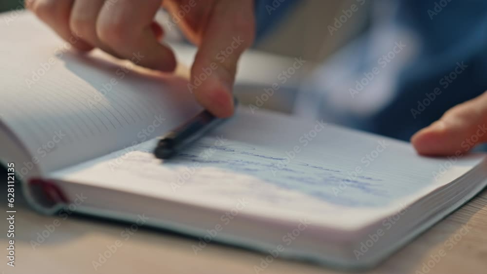 Closeup businessman hands writing notes at desk. Man preparing schedule notebook
