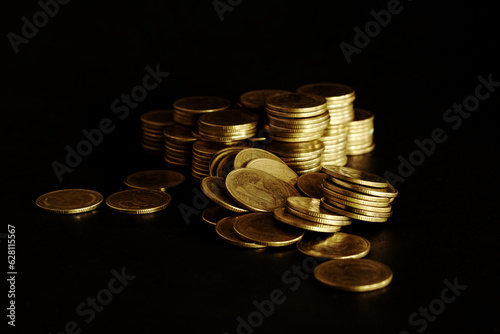 pile of coins on black background