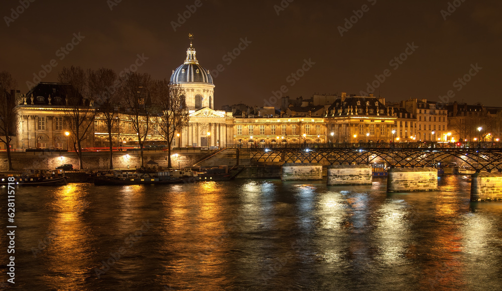 Fototapeta premium River Seine with Pont des Arts and Institut de France panorama at night in Paris, France. High quality photo