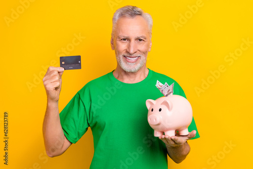 Foto Portrait of positive aged person beaming smile arms hold debit card money pig ba