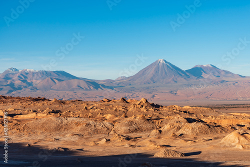 Volcanic snowy peak viewed from Vallecito in Atacama desert photo