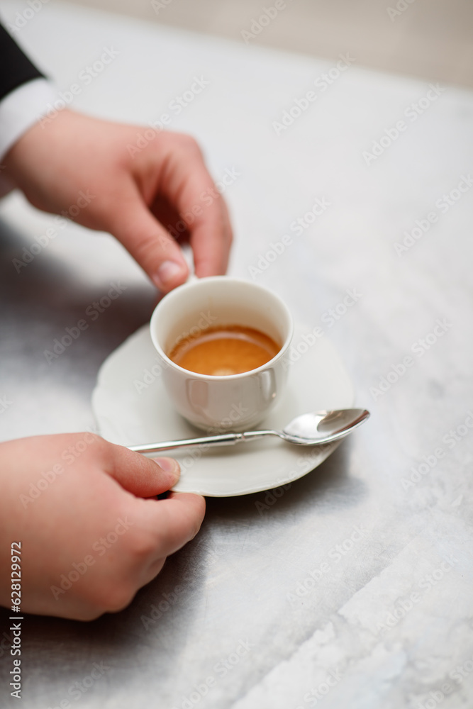 Top shot for professional serving a cup of coffee Top shot for professional serving a cup of coffee