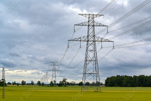 Power lines over fields a cloudy summers day