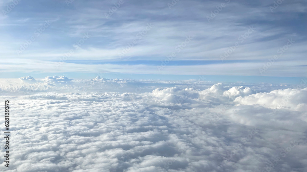 Clouds against the blue sky from the airplane window