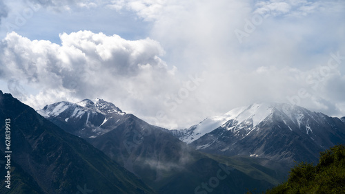 cloudy weather in a mountain gorge. clouds over mountain peaks