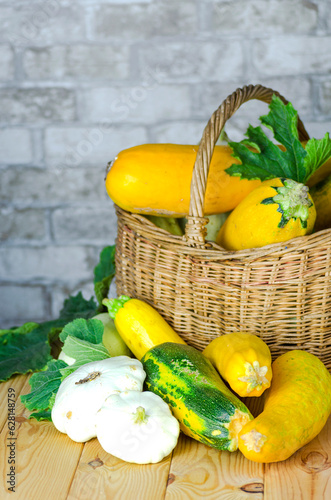fresh zucchini and squash in a wicker basket