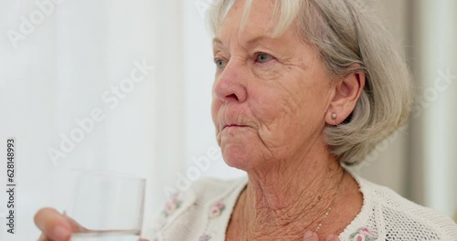Health, thirsty and mature woman drinking water for hydration and liquid diet detox at home. Wellness, fresh and calm elderly female person enjoying glass of cold drink in modern retirement house.