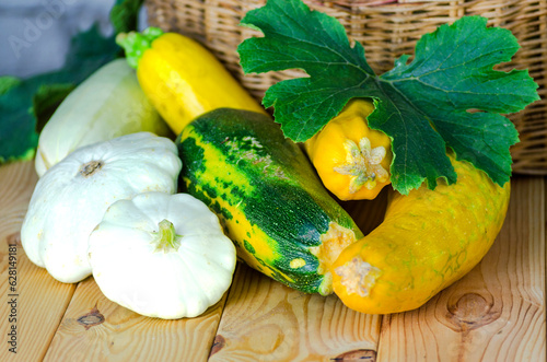 fresh zucchini and squash in a wicker basket