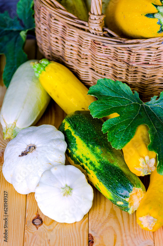 fresh zucchini and squash in a wicker basket