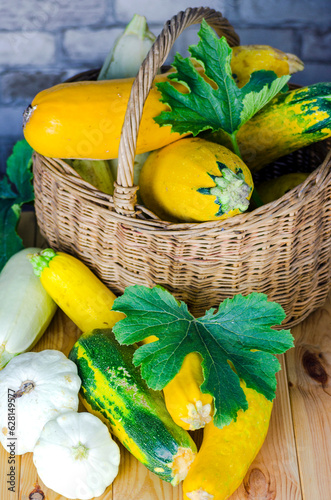fresh zucchini and squash in a wicker basket