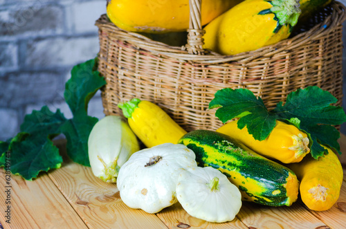 fresh zucchini and squash in a wicker basket