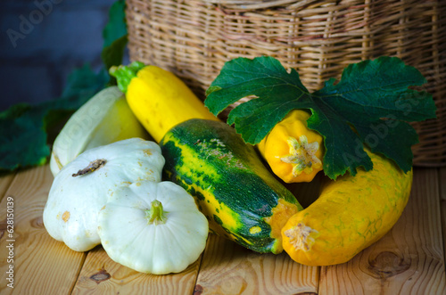 fresh zucchini and squash in a wicker basket