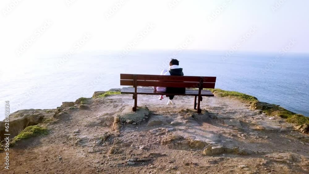 Mother and daughter sitting on the most beautiful bench in the world, Loiba. Mother and daughter sitting on the most beautiful bench in the world, Loiba.