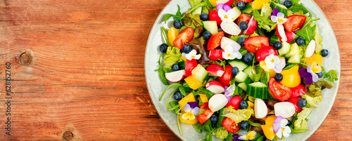Summer salad with edible flowers,space for text.