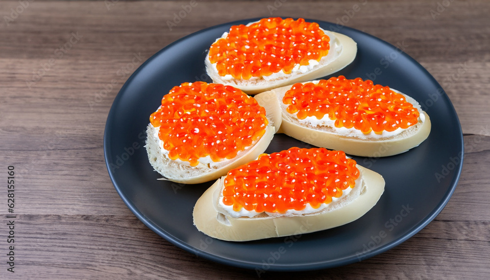 Caviar Sandwich on dark plate on wooden background with copy space Caviar Sandwich on dark plate on wooden background with copy space