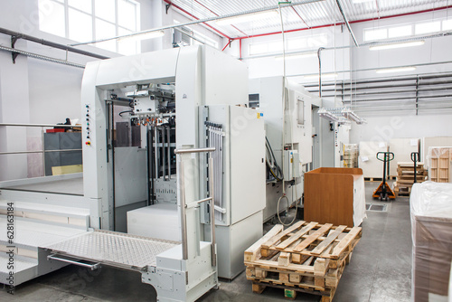 The equipment for a press. Offset machine at the printing manufacturing. Printing machine photo