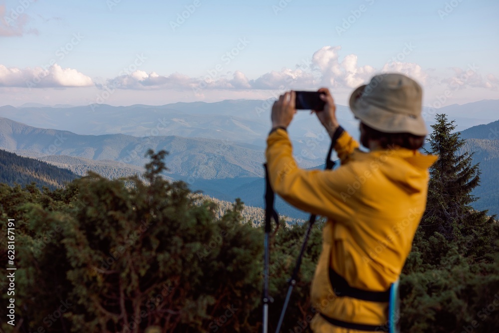 blurred silhouette of a traveler on the background of evening mountain landscapes