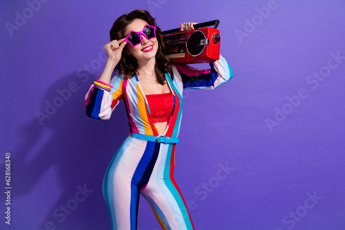 Photo of funky cool lady wear striped overall listening boom box discotheque songs empty space isolated purple color background