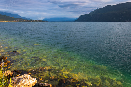 View of the Bourget lake and Jura mountains. Savoie, France. Sunset light reflection in clear water. Stunning earth places landscape background. Nature travel, environment and ecology concepts. photo