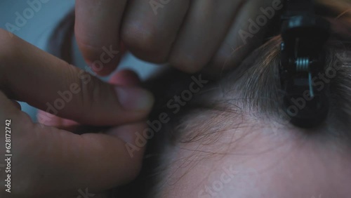 Process of weaving making boxer braids cornrows by a hair braider. photo