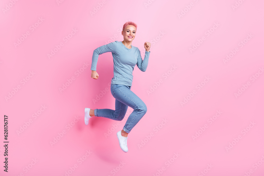 Full size photo of pleasant pretty nice girl dressed blue shirt pants running shopping empty space isolated on pink color background Full size photo of pleasant pretty nice girl dressed blue shirt pants running shopping empty space isolated on pink color background