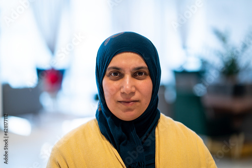 Positive adult Middle Eastern woman with hijab