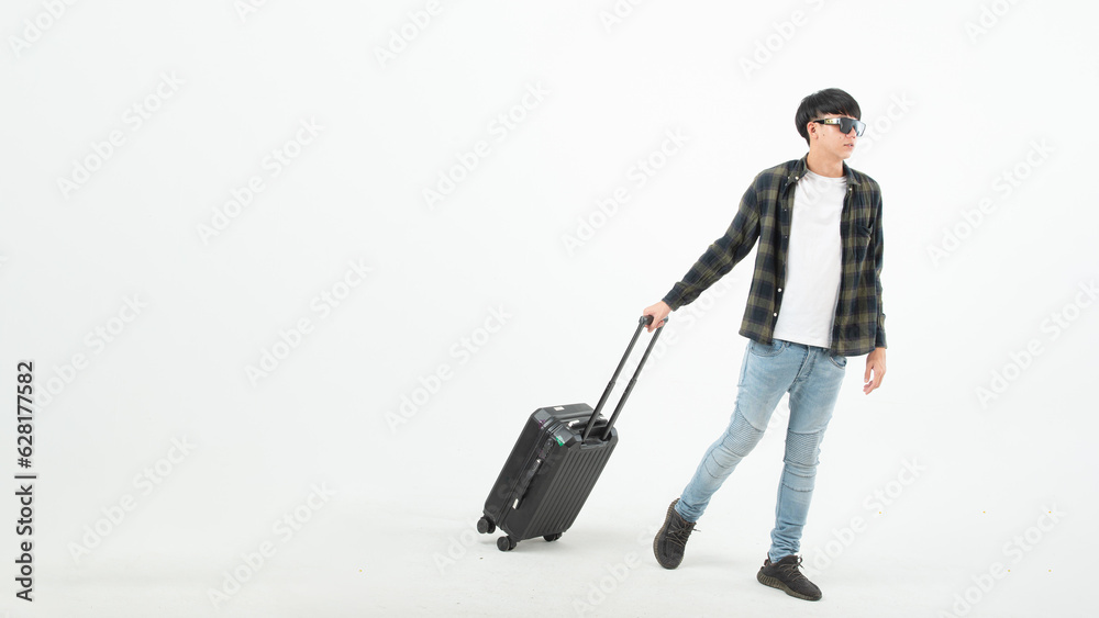 Happy asian man holding passport and tickets, ready to travel, sitting near suitcase and smiling at camera over light wall. Cheerful male traveller ready for vacation, on white background Happy asian man holding passport and tickets, ready to travel, sitting near suitcase and smiling at camera over light wall. Cheerful male traveller ready for vacation, on white background