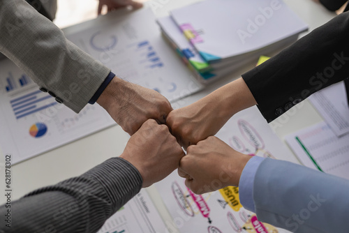 A group of business people join hands to successfully make contact, work as a team to achieve goals, hand-to-hand coordination is a symbol of unity within the organization to strive for success.