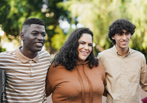 Young diverse people hugging each other outdoor - Curvy woman smiling on camera