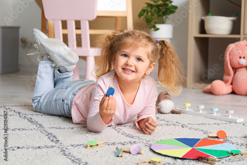 Cute little girl playing ma...