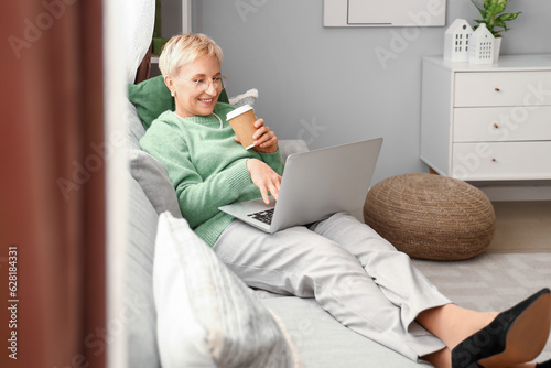 Mature woman with cup of co...