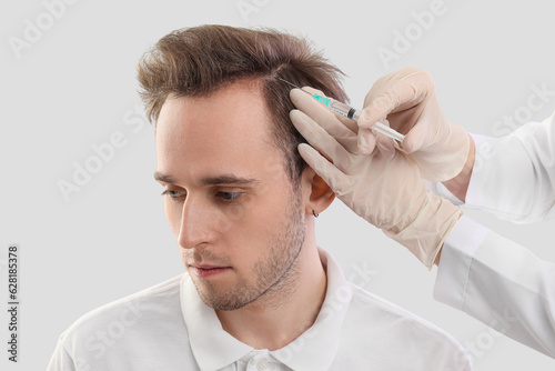 Young man receiving injecti...