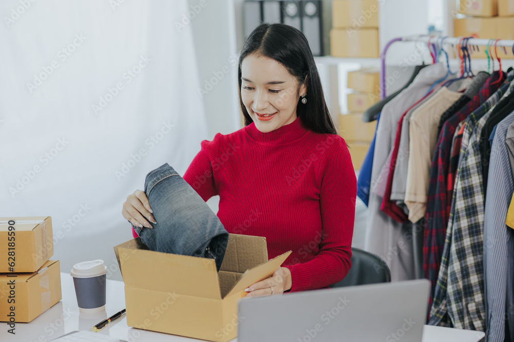 Beautiful asian woman wearing red shirt, presenting fashionable clothes, live video, social media, her record, selling online via digital camera, sme or small business ecommerce concept. Beautiful asian woman wearing red shirt, presenting fashionable clothes, live video, social media, her record, selling online via digital camera, sme or small business ecommerce concept.