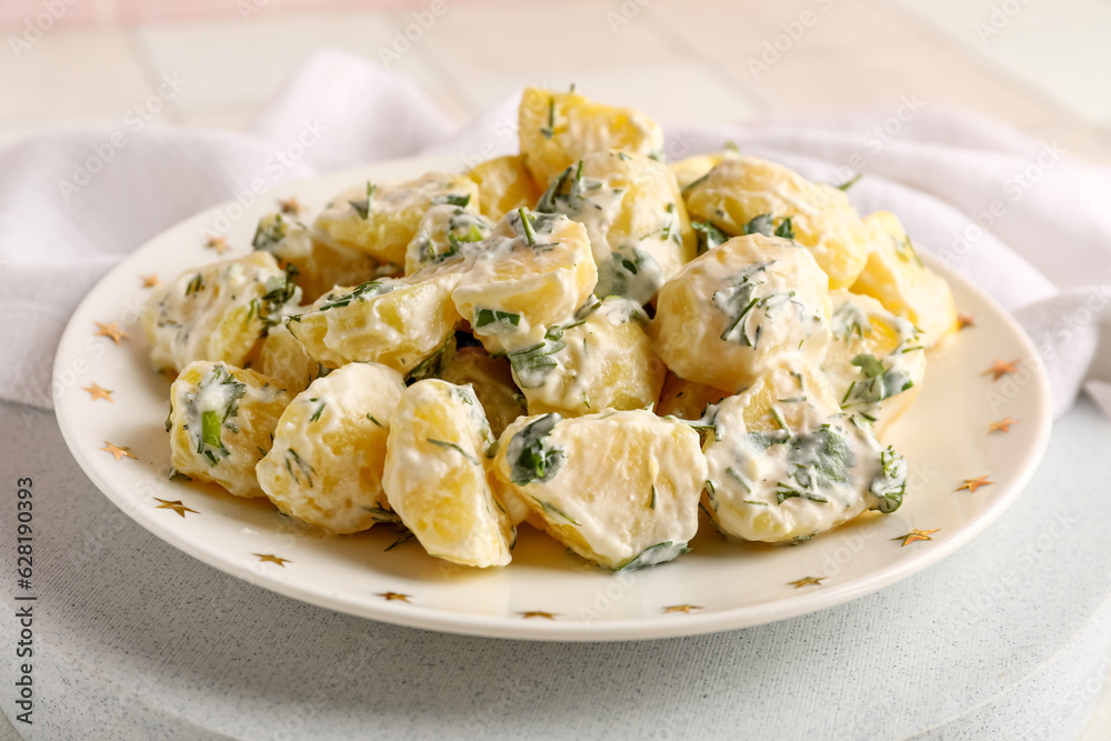 Plate of tasty Potato Salad with greens on table, closeup Plate of tasty Potato Salad with greens on table, closeup