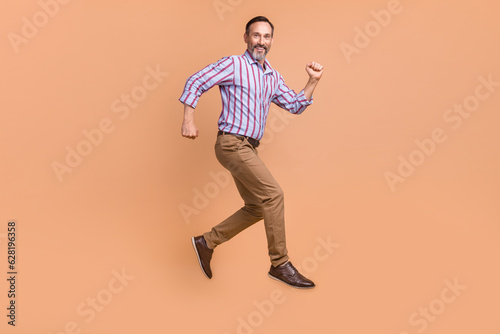 Full length profile portrait of crazy cheerful elegant person jumping run good mood isolated on beige color background