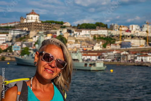 Porto, Portugal - Female traveller enjoying the stunning sunset above the Douro river in Porto during summer photo
