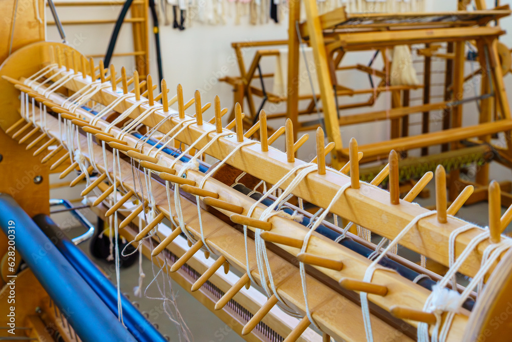 Close-up of a floor loom sectional warping dowels in a textile weaving studio Close-up of a floor loom sectional warping dowels in a textile weaving studio