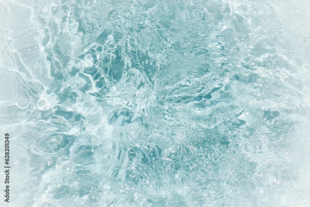 Blue water with ripples on the surface. Defocus blurred transparent blue colored clear calm water surface texture with splashes and bubbles. Water waves with shining pattern texture background. Blue water with ripples on the surface. Defocus blurred transparent blue colored clear calm water surface texture with splashes and bubbles. Water waves with shining pattern texture background.