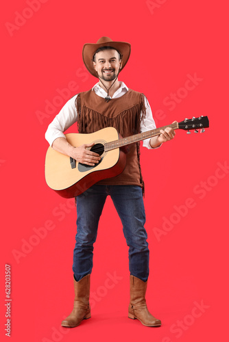Handsome cowboy playing gui...