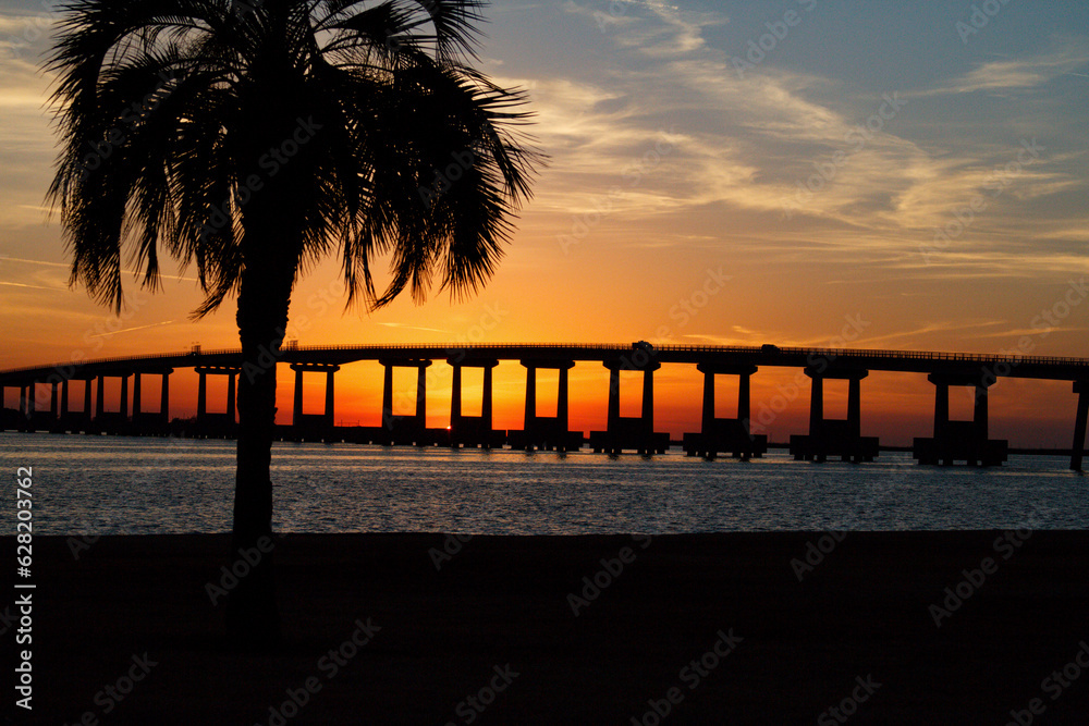 Naklejka premium Sunset over the bridge in the Rigolets.